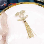 Studded letter tassel brooch